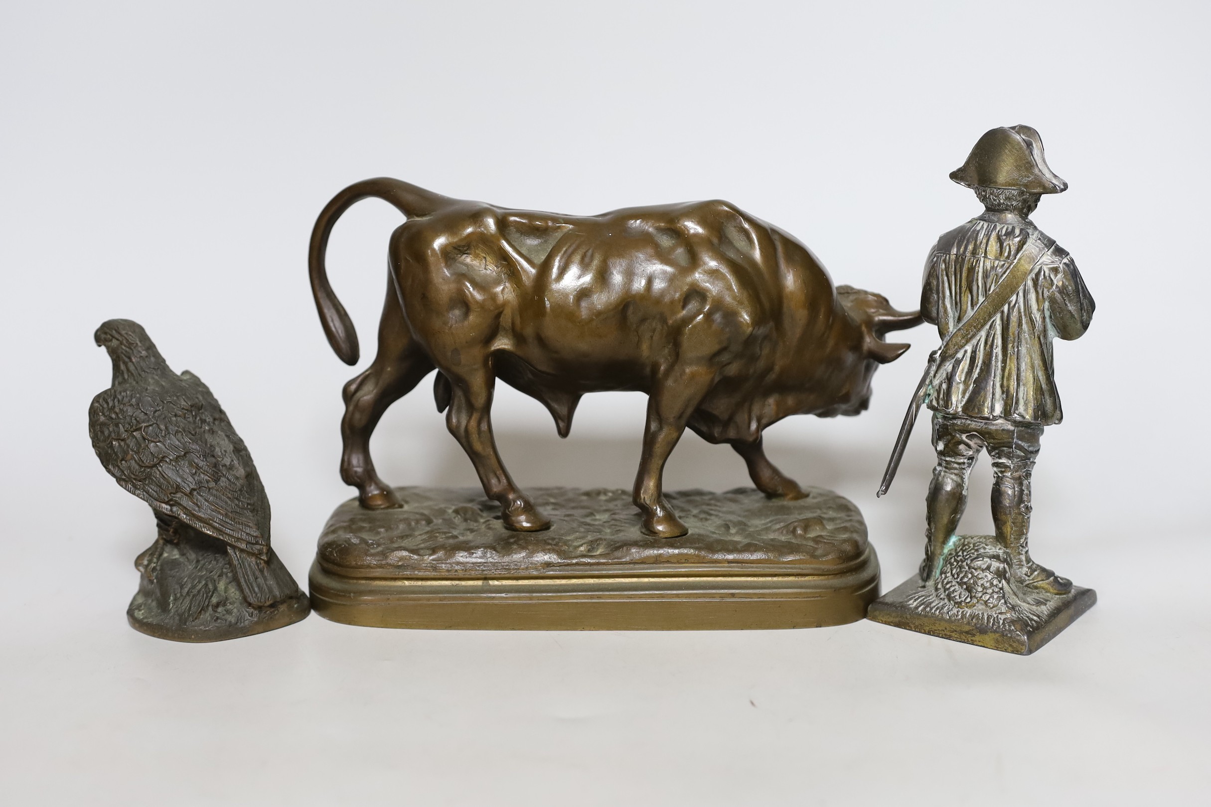 A bronze figure of a cow, together with two other figures, tallest 18cm